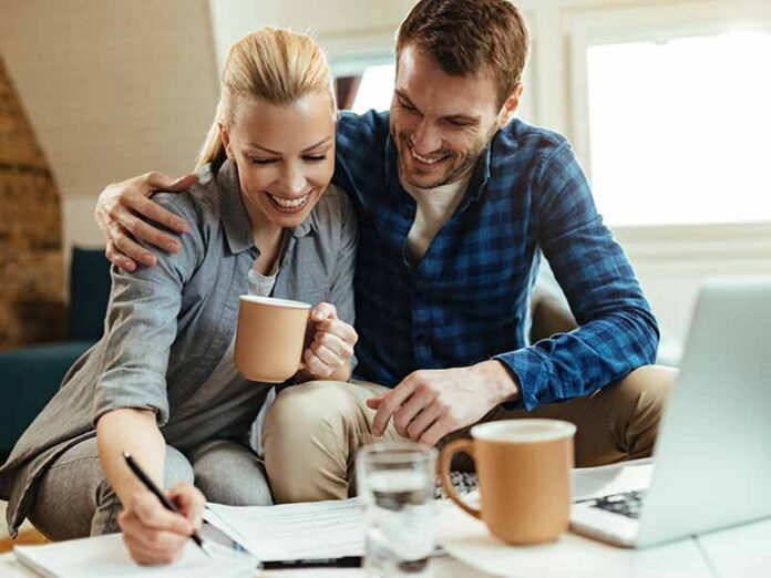 Couple discussing finances and budgeting together at home